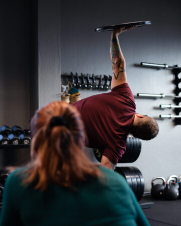 Man som lyfter viktplatta i balansövning. Enskild personlig träning hos Health Power i Mjölby.
